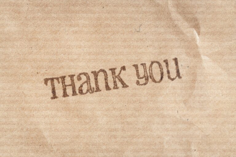 Thank you ink stamp on kraft paper. Full frame